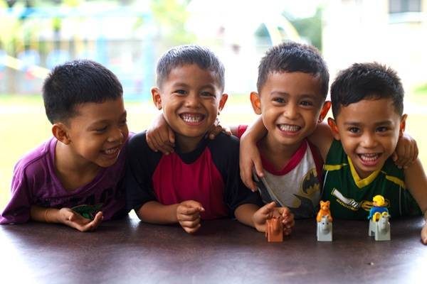 Four boys laughing.