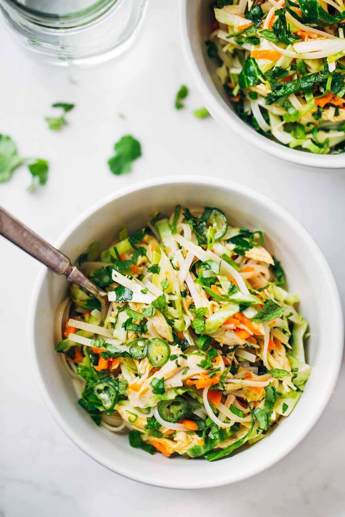Vietnamese Chicken Salad with Rice Noodles in a white bowl with a fork.